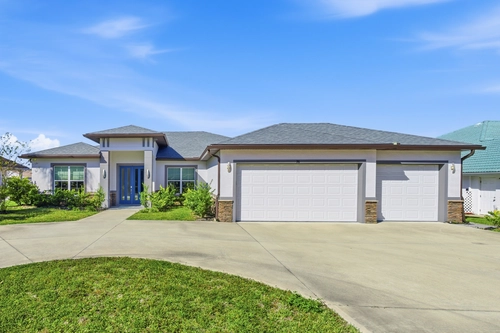 Canal front beach house with heated pool, boat dock, sunset views, kayaks, bikes, and pet-friendly—5 minutes to the beach