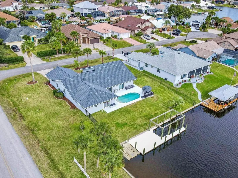 Escape to our Waterside Paradise! With a dock for your boat or jet ski, enjoy coastal living in our spacious 4 BR, 3 bath pool home.
